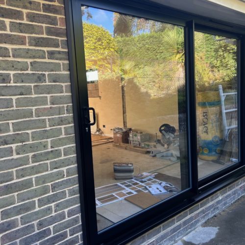 Black 2 paned sliding doors with TV and standard glass